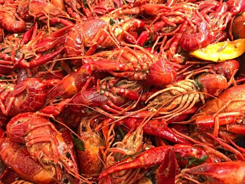 Cooked spicy red crayfish piled together at Sup Crab Pompano Beach, a Seafood Restaurant in Pompano Beach