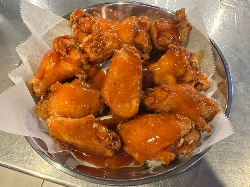 Sauce-glazed crispy fried chicken wings at Sup Crab Pompano Beach, a Seafood Restaurant in Pompano Beach